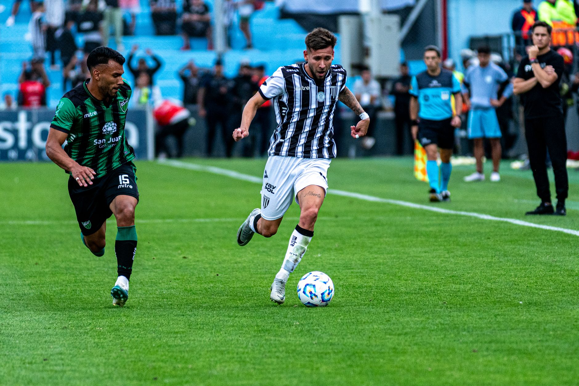 Two soccer players in action during a dynamic game on a green field.
