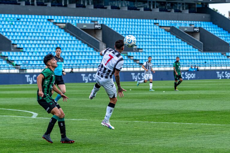 Action-packed soccer match with players competing in a vibrant stadium.