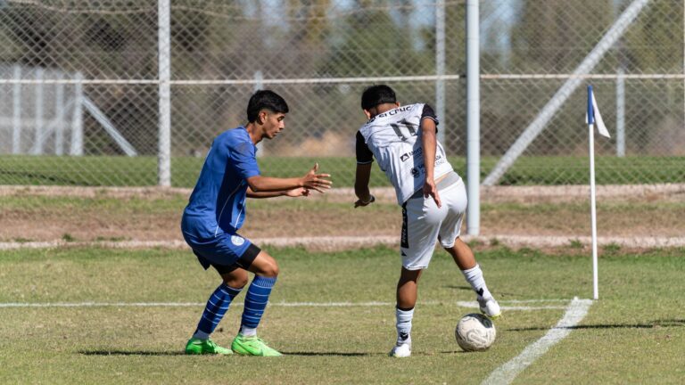 Two young soccer players in competitive action on the field.