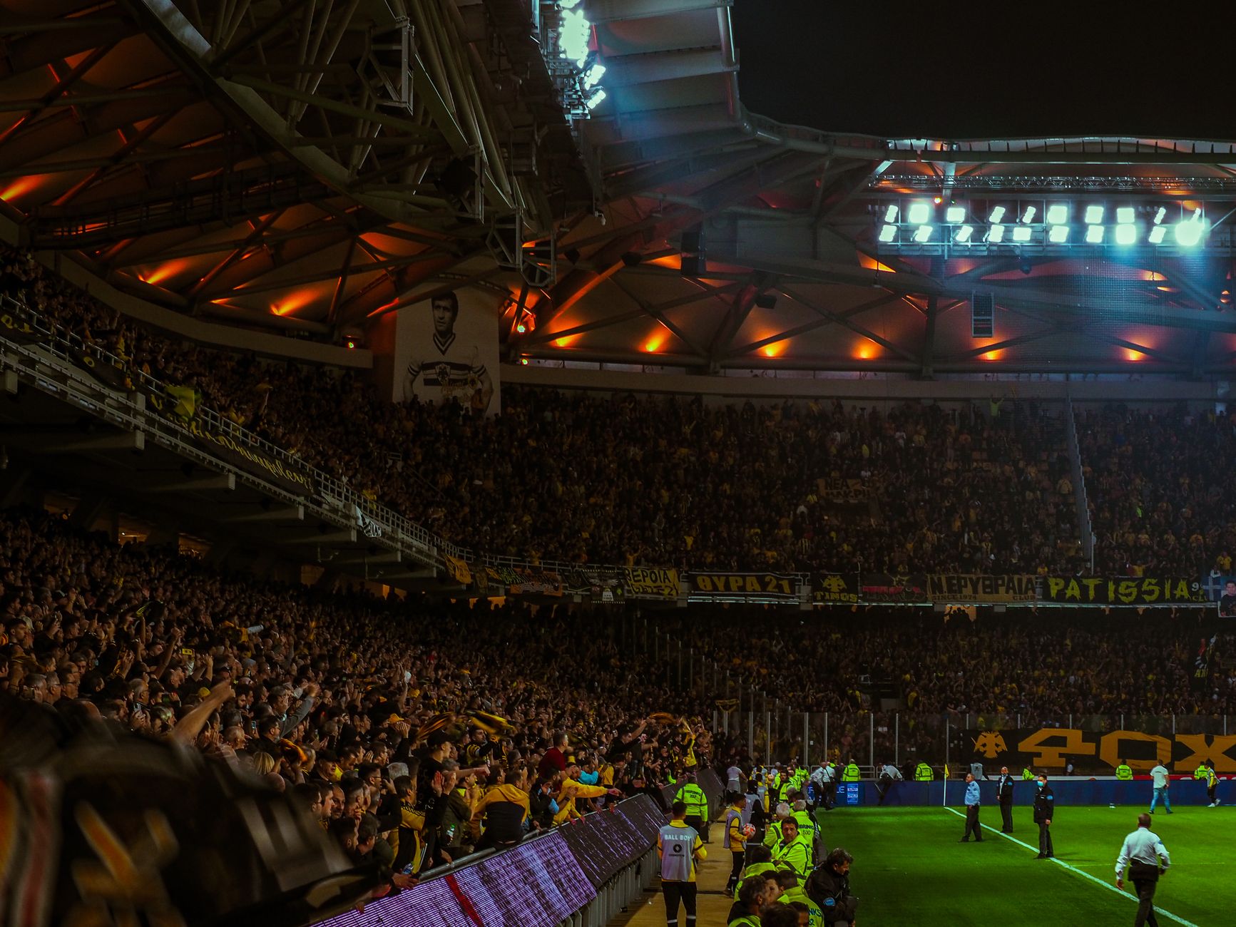 Exciting night soccer game with packed cheering fans and vibrant stadium lights.