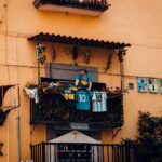 A balcony decorated with football jerseys and player photographs, showcasing a tribute to soccer legends.