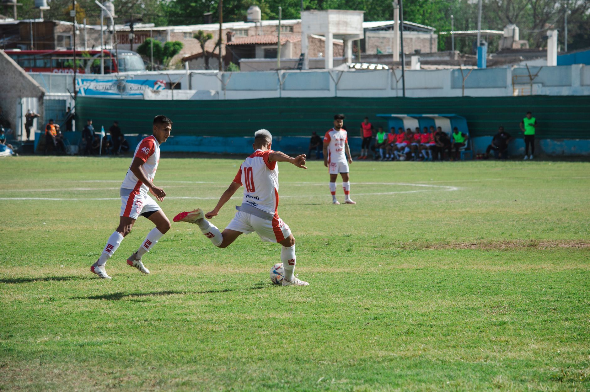 Intense soccer game in Mina, Mendoza, Argentina showcasing teamwork and action on a sunny day.
