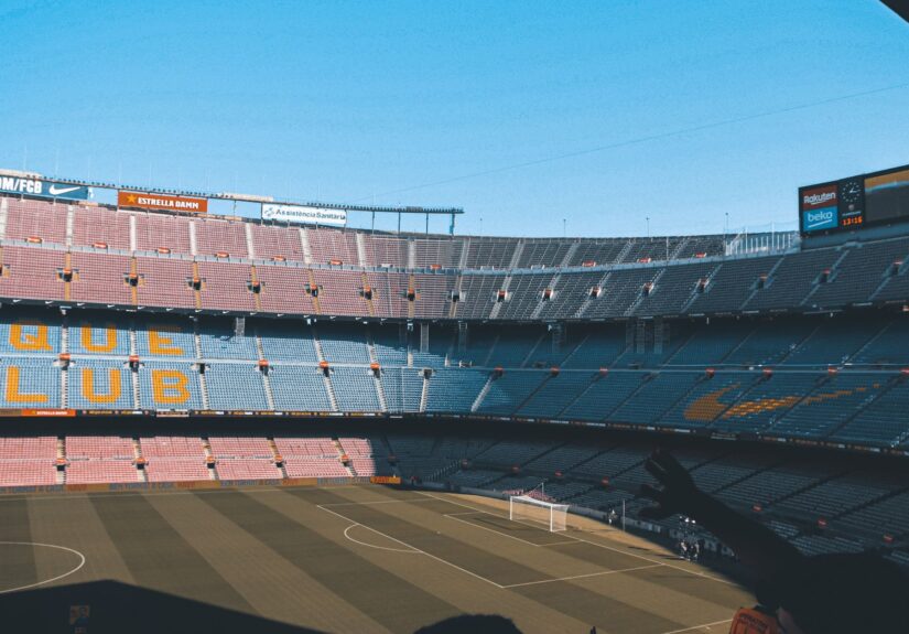 Wide shot of the iconic Camp Nou stadium in Barcelona, showcasing empty seats and football field.
