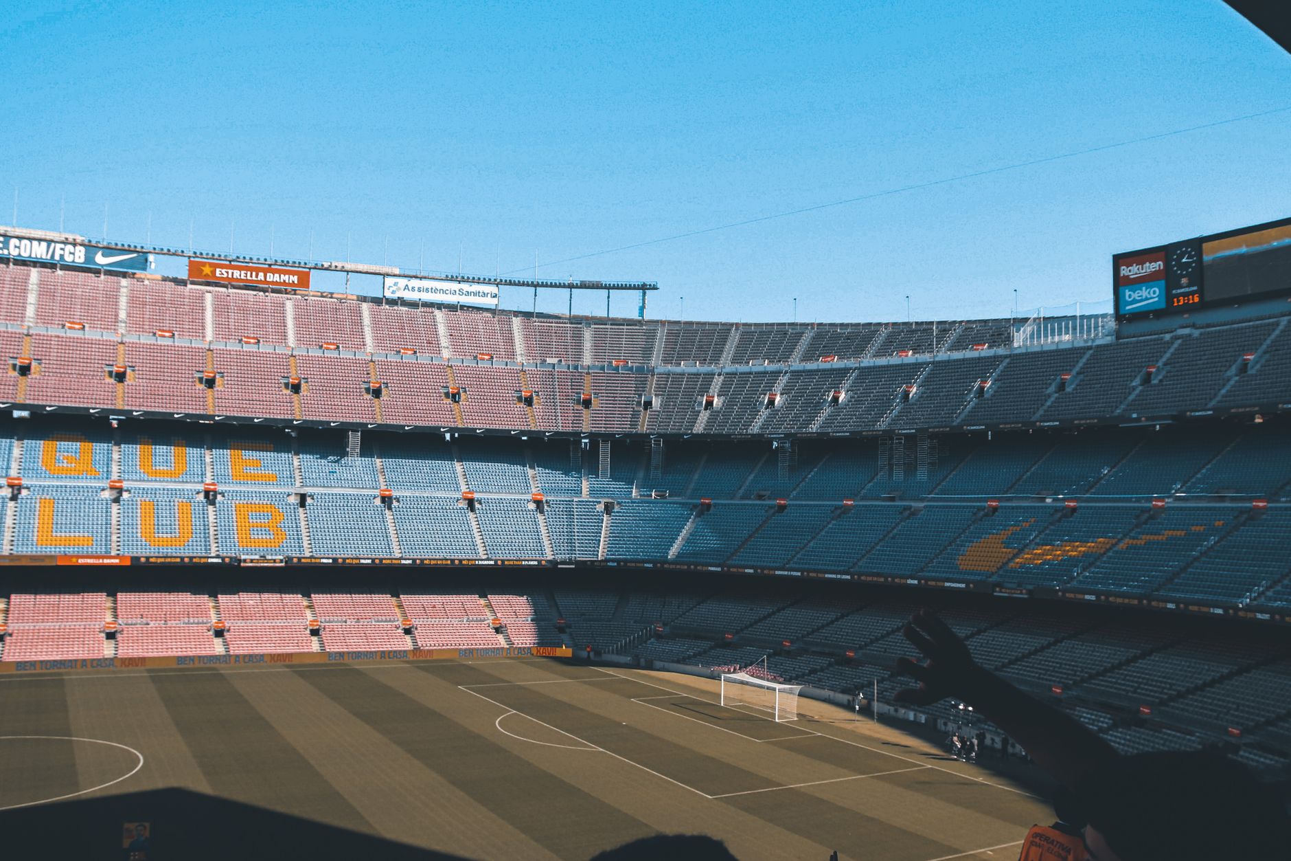 Wide shot of the iconic Camp Nou stadium in Barcelona, showcasing empty seats and football field.